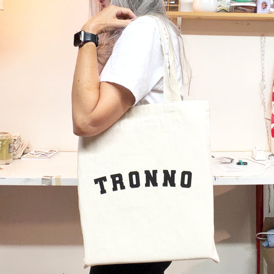 A tote bag original design with the word TRONNO on the face and hand screen printed by havyn in Toronto